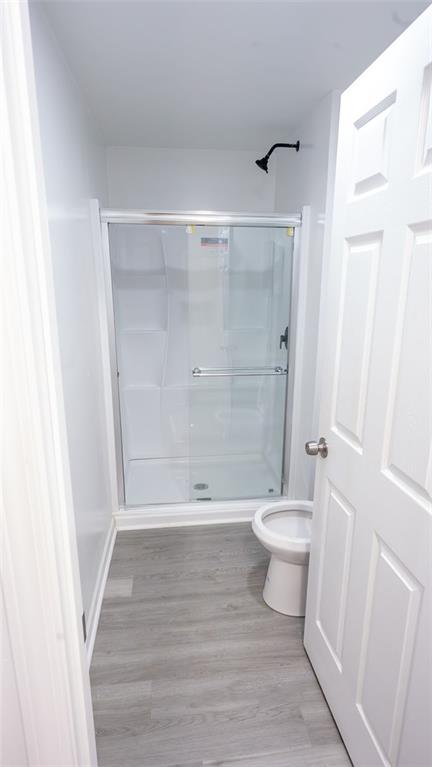 3171 Redwood Run Atlanta, GA 30349 - Photo 4 of 7 a bathroom with a toilet and a shower
