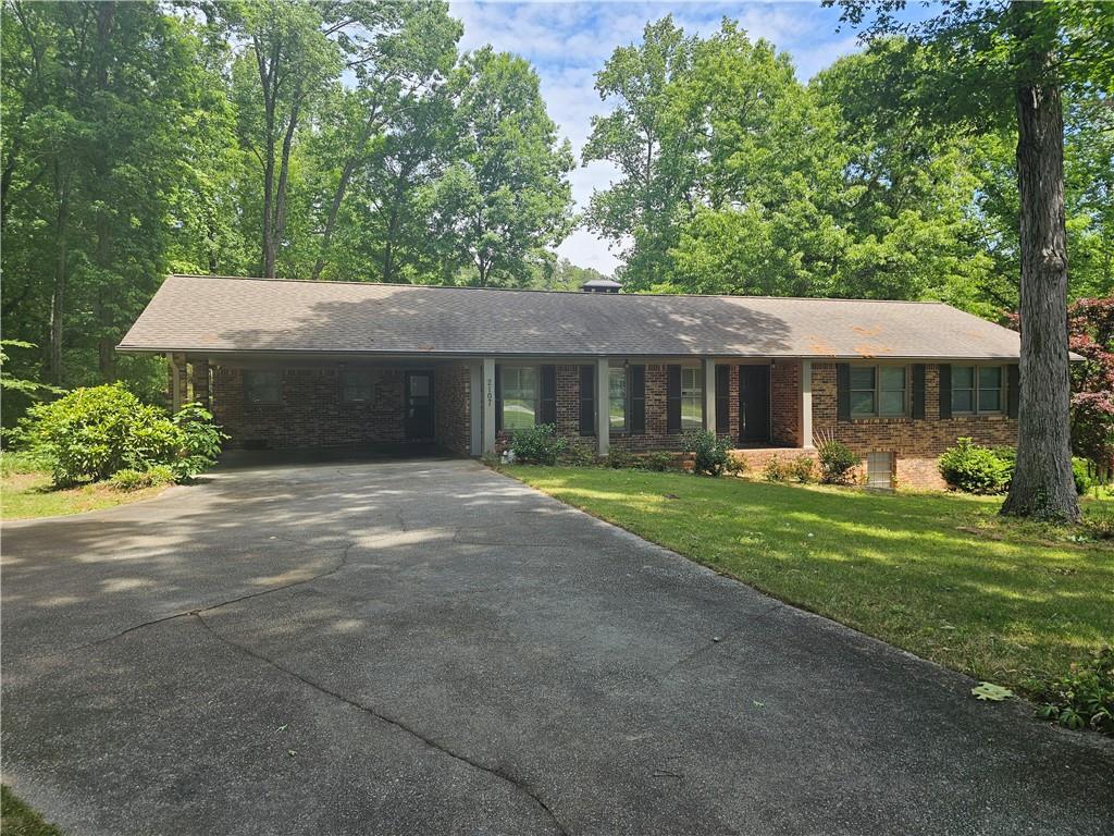 2107 Flat Shoals Road Southwest Conyers, GA 30094 - Photo 2 of 21 a front view of a house with a yard