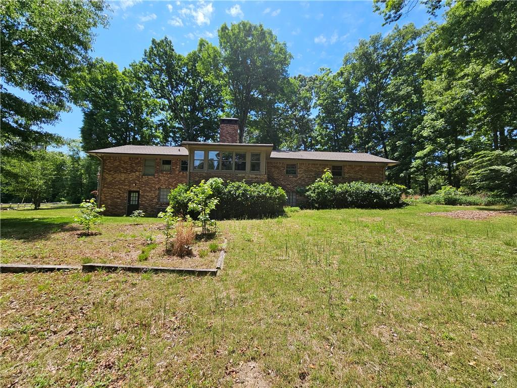 2107 Flat Shoals Road Southwest Conyers, GA 30094 - Photo 21 of 21 a backyard of a house with lots of green space