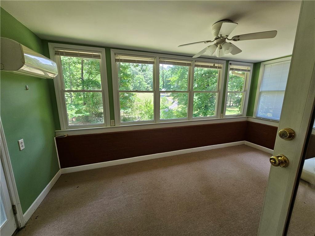 2107 Flat Shoals Road Southwest Conyers, GA 30094 - Photo 7 of 21 a view of an empty room with a window