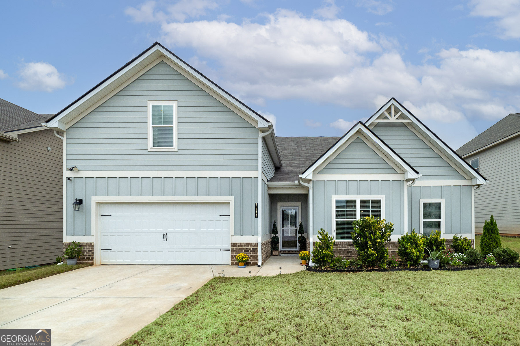 a front view of a house with a yard and garage