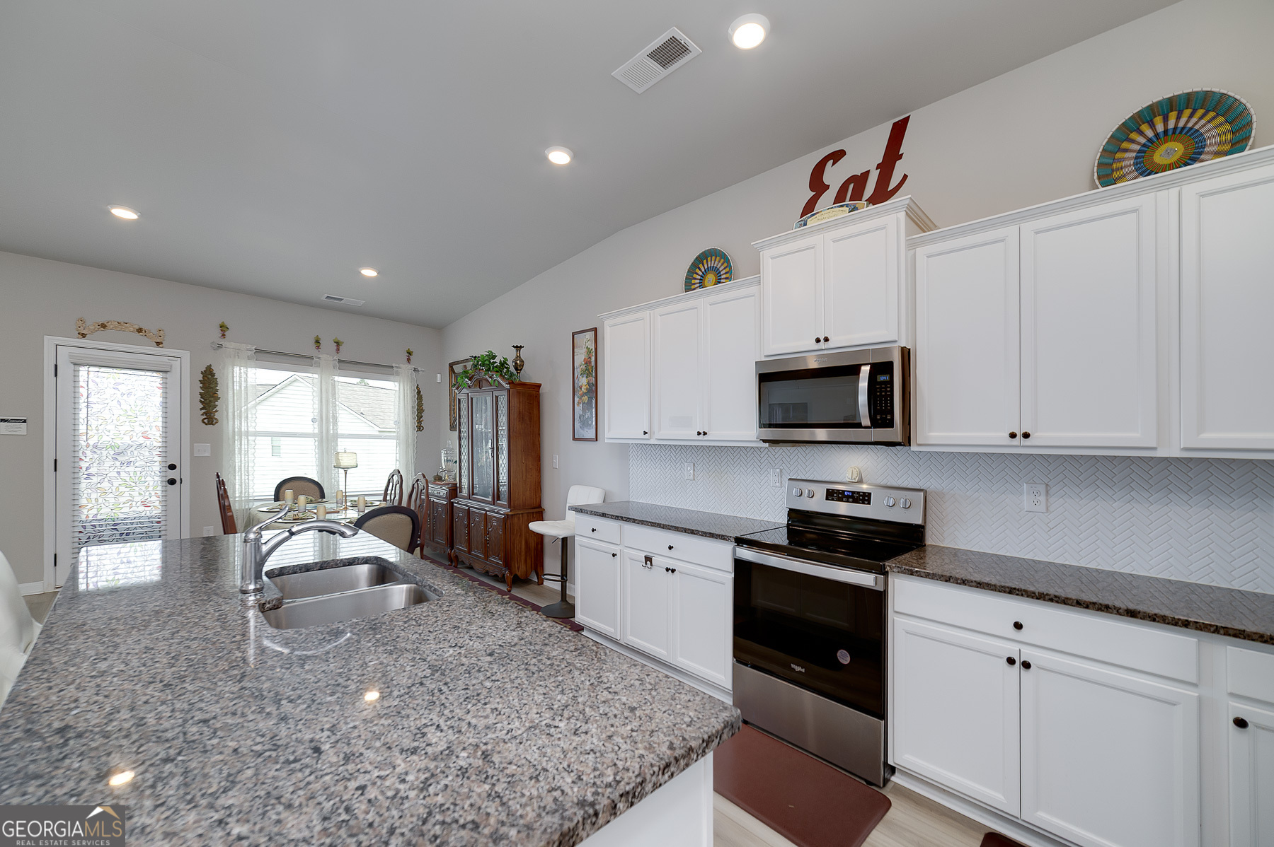 1517 Stinson Lane, Unit PHASE Locust Grove, GA 30248 - Photo 16 of 46 a kitchen with stainless steel appliances granite countertop a sink a stove and cabinets