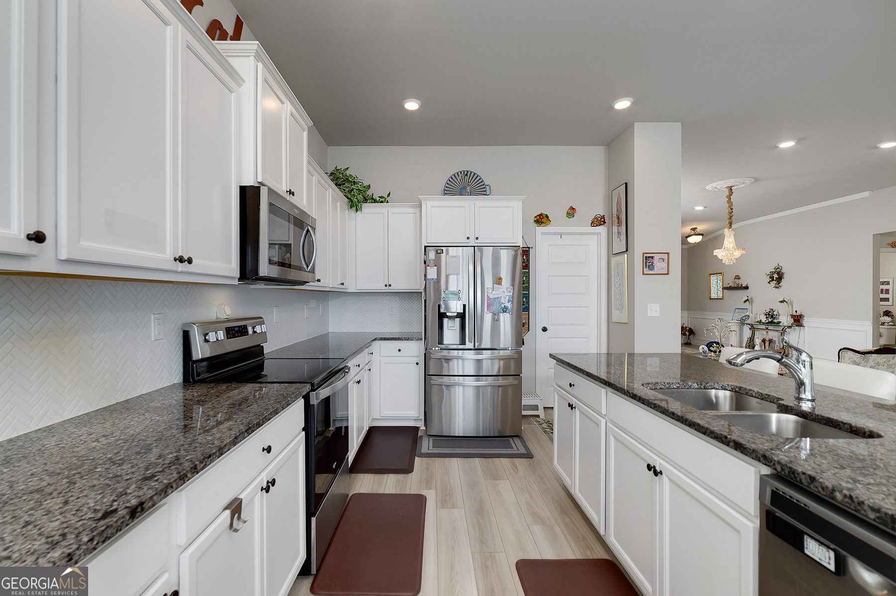 1517 Stinson Lane, Unit PHASE Locust Grove, GA 30248 - Photo 17 of 46 a kitchen with stainless steel appliances granite countertop a sink stove and refrigerator