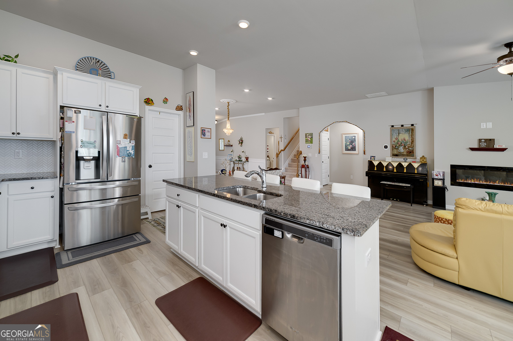 1517 Stinson Lane, Unit PHASE Locust Grove, GA 30248 - Photo 18 of 46 a kitchen with stainless steel appliances kitchen island granite countertop a refrigerator a stove and a sink
