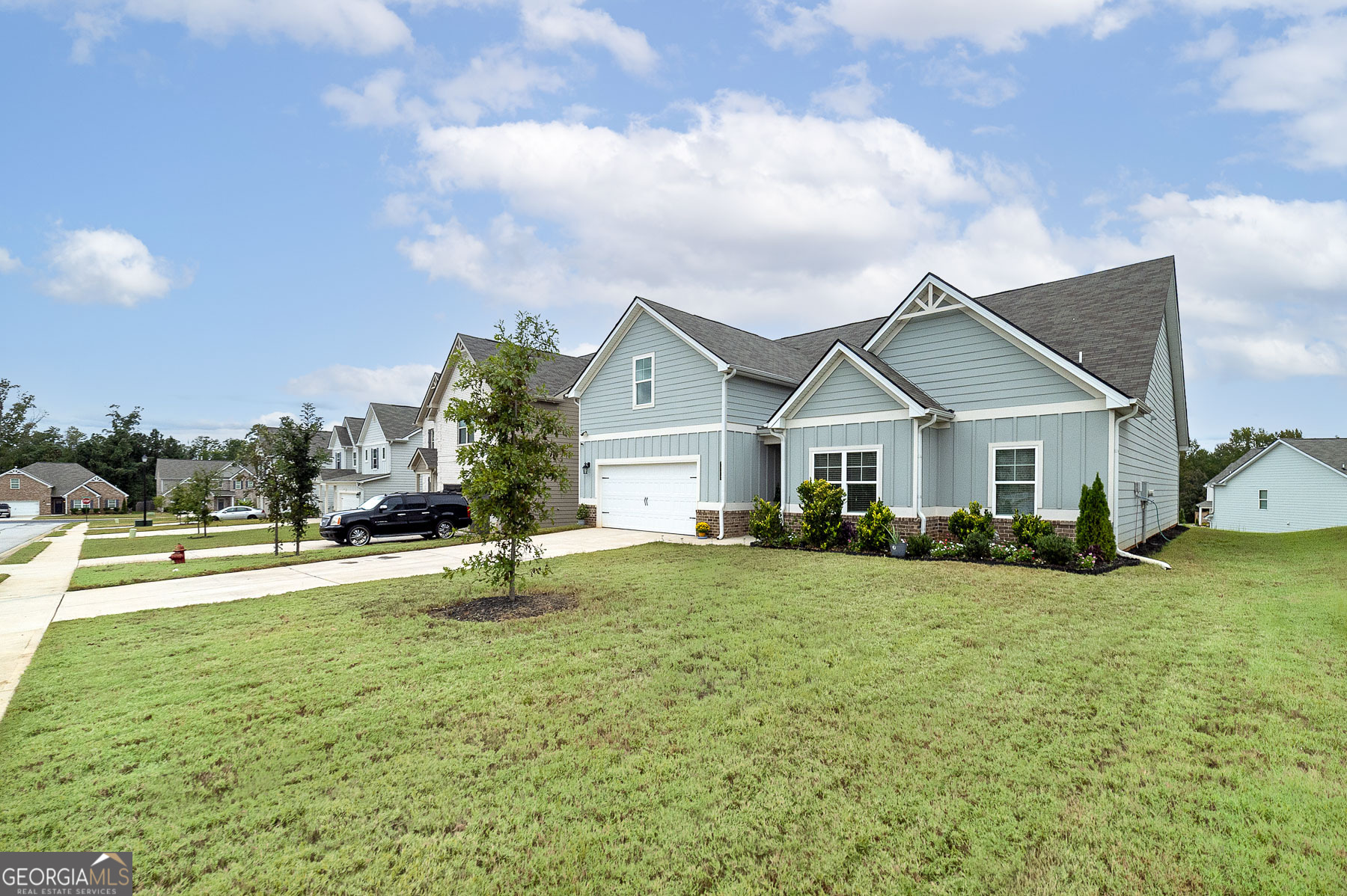 1517 Stinson Lane, Unit PHASE Locust Grove, GA 30248 - Photo 2 of 46 a house view with a garden space
