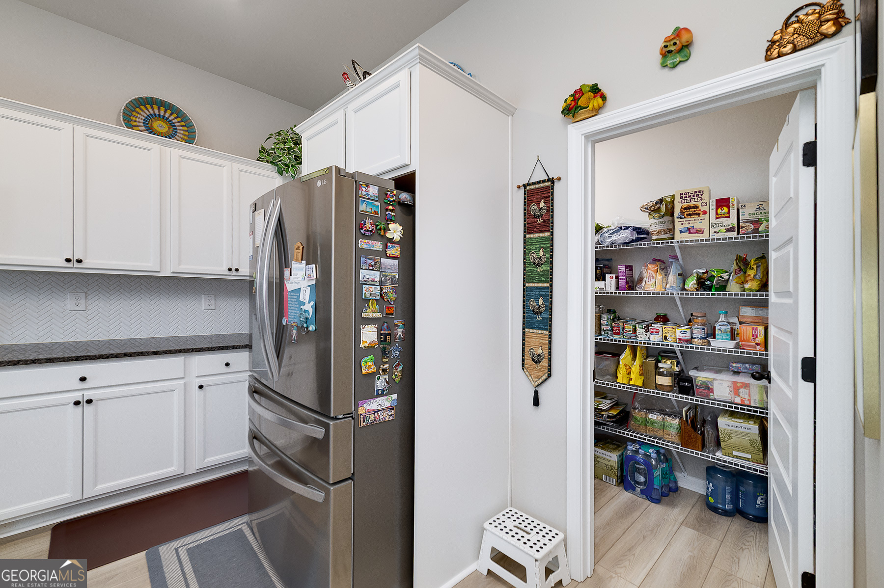 1517 Stinson Lane, Unit PHASE Locust Grove, GA 30248 - Photo 22 of 46 a kitchen with stainless steel appliances a refrigerator and a wooden floor