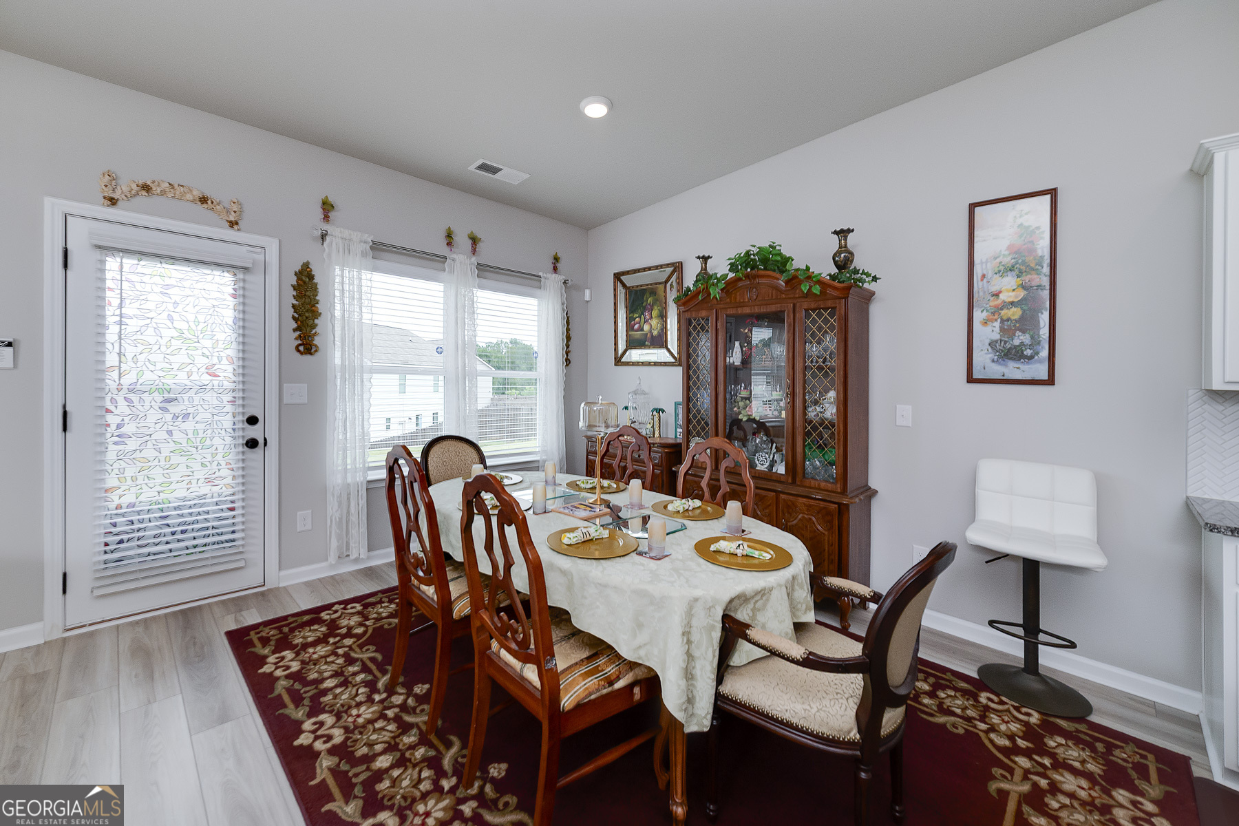 1517 Stinson Lane, Unit PHASE Locust Grove, GA 30248 - Photo 23 of 46 a view of a dining room with furniture and wooden floor
