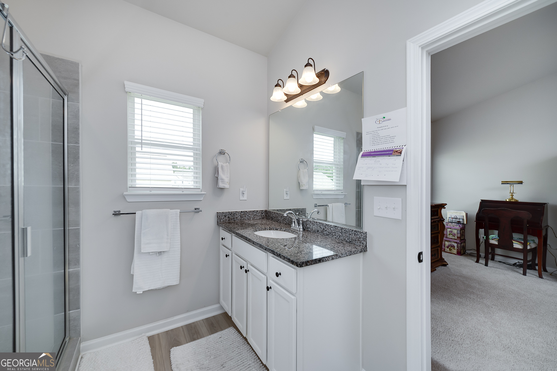 1517 Stinson Lane, Unit PHASE Locust Grove, GA 30248 - Photo 30 of 46 a bathroom with a granite countertop sink a mirror and a window
