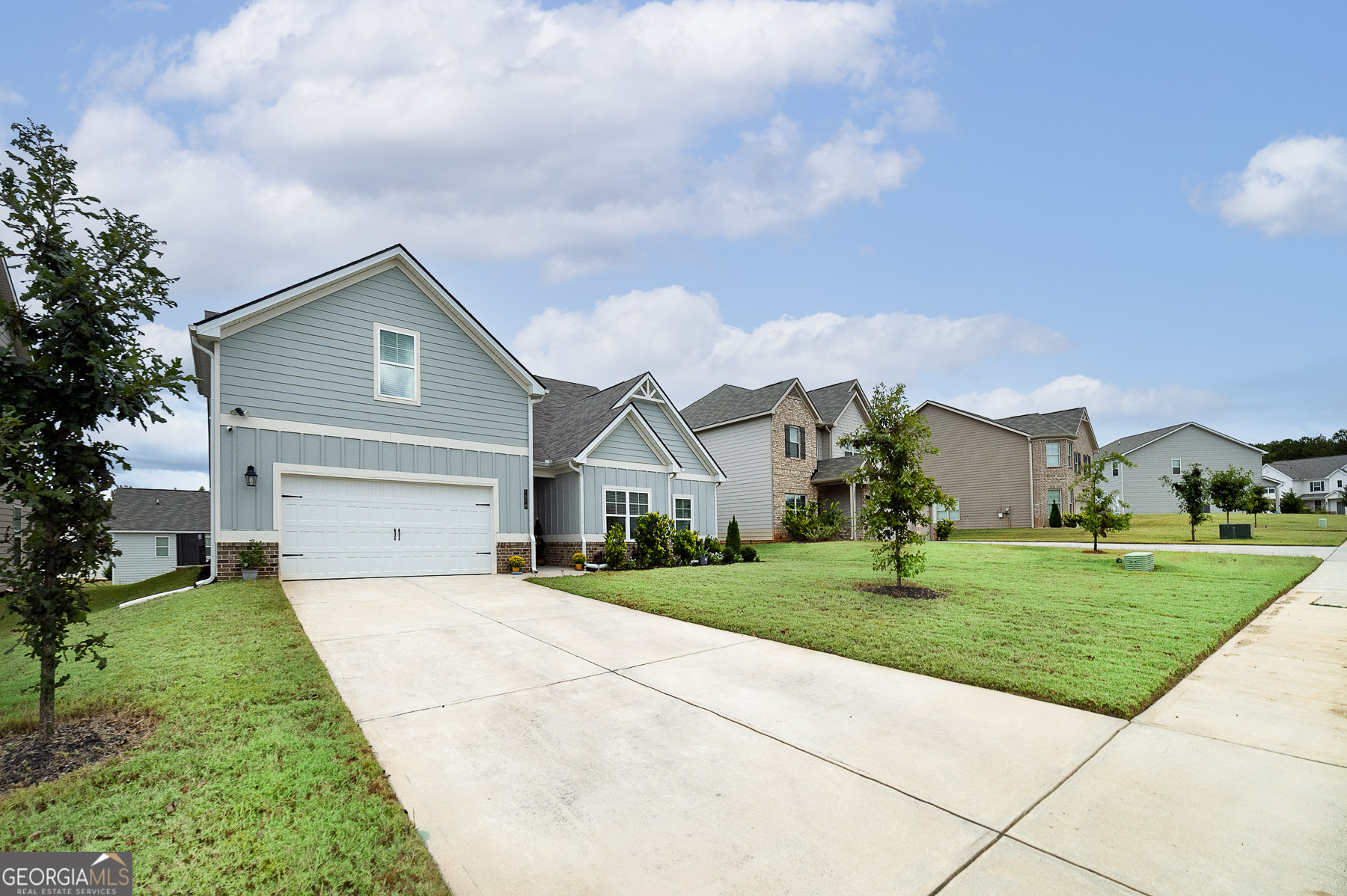1517 Stinson Lane, Unit PHASE Locust Grove, GA 30248 - Photo 3 of 46 a front view of a house with a yard and garage