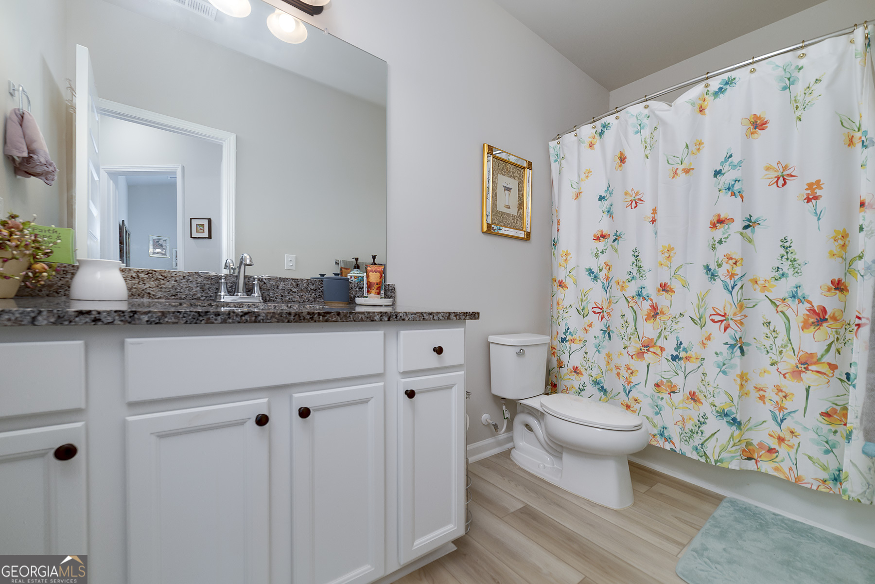 1517 Stinson Lane, Unit PHASE Locust Grove, GA 30248 - Photo 35 of 46 a bathroom with a granite countertop sink and a mirror