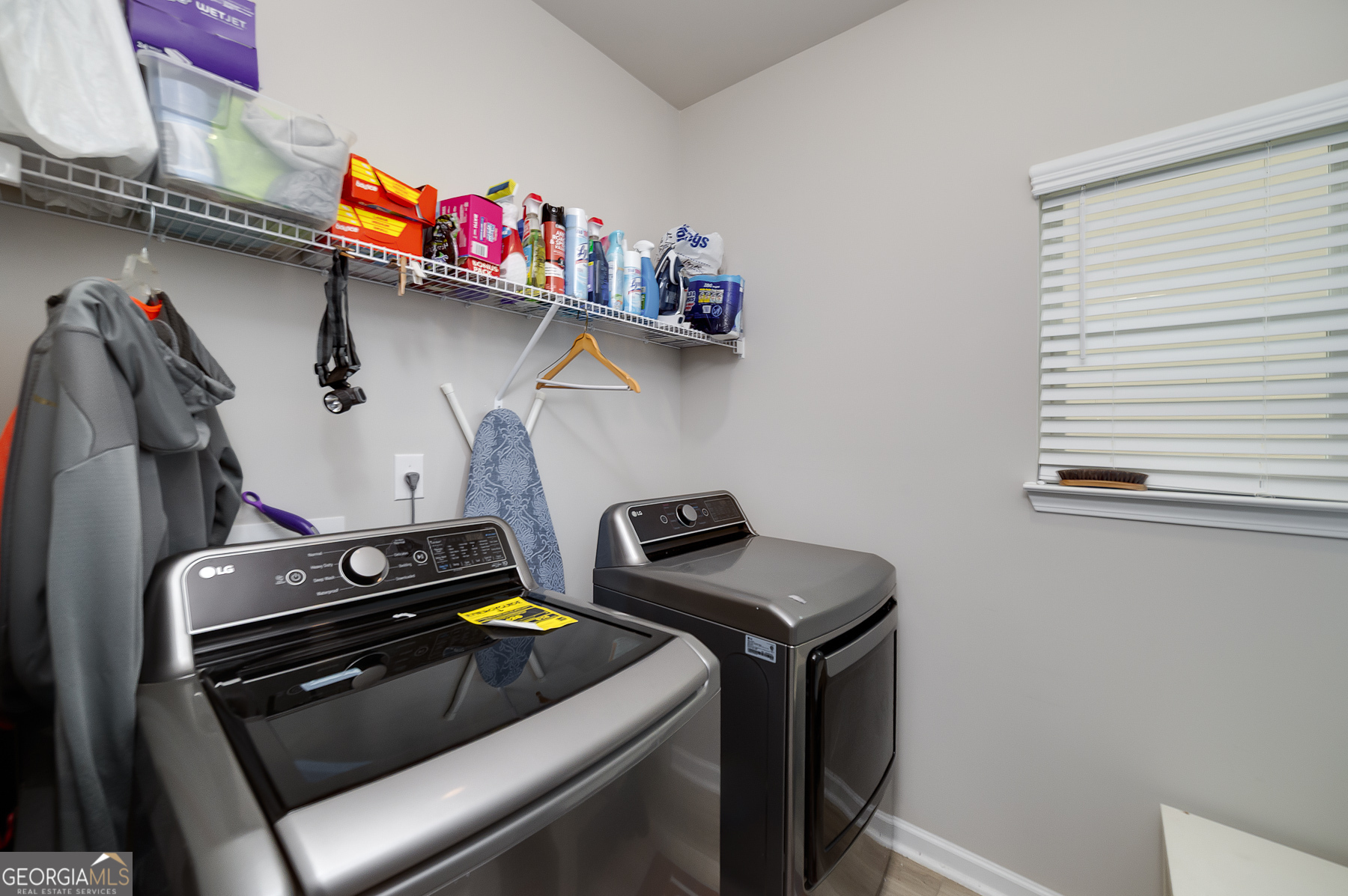 1517 Stinson Lane, Unit PHASE Locust Grove, GA 30248 - Photo 41 of 46 a utility room with dryer washer and a view of living room