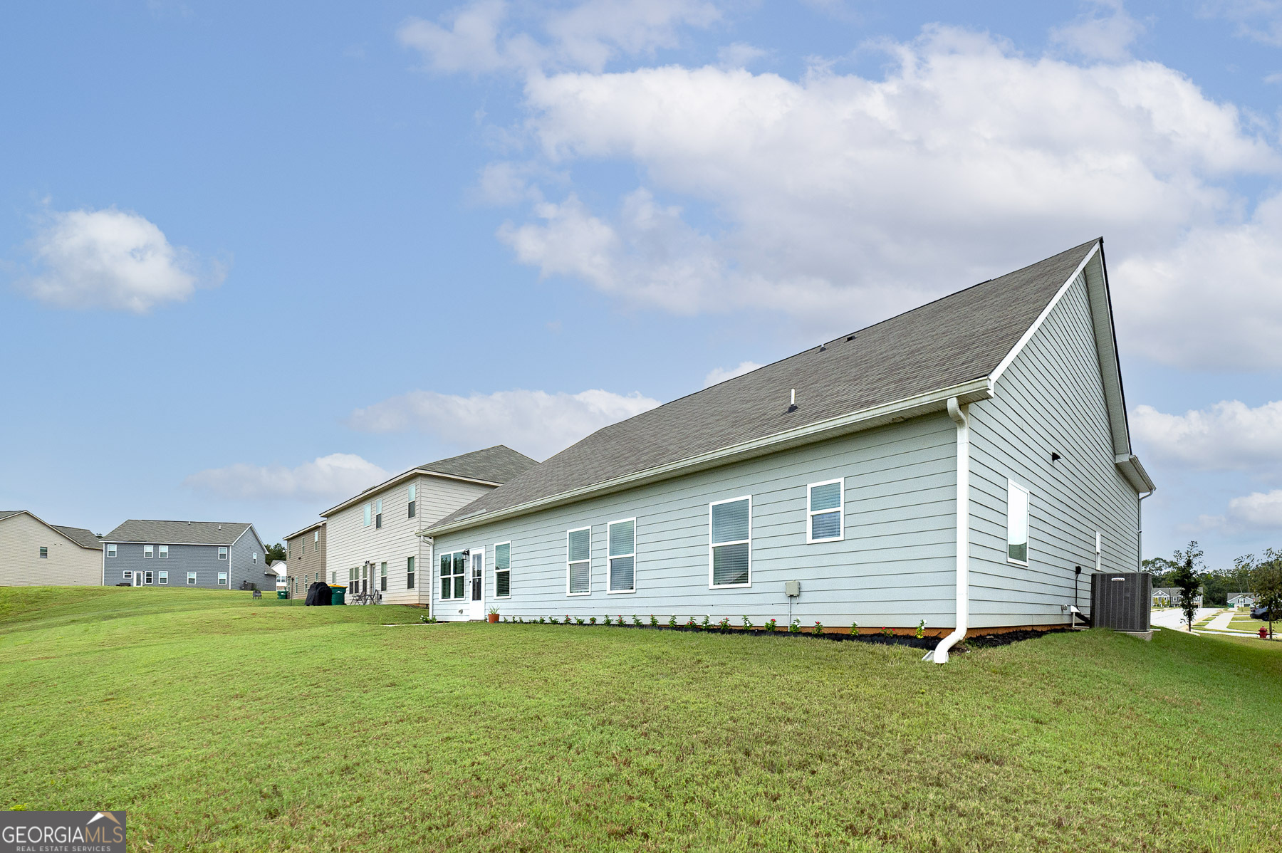1517 Stinson Lane, Unit PHASE Locust Grove, GA 30248 - Photo 6 of 46 a backyard of a house with table and chairs