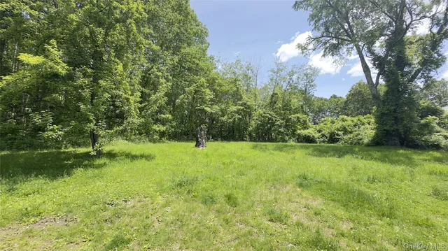 a view of backyard with swimming pool and outdoor seating