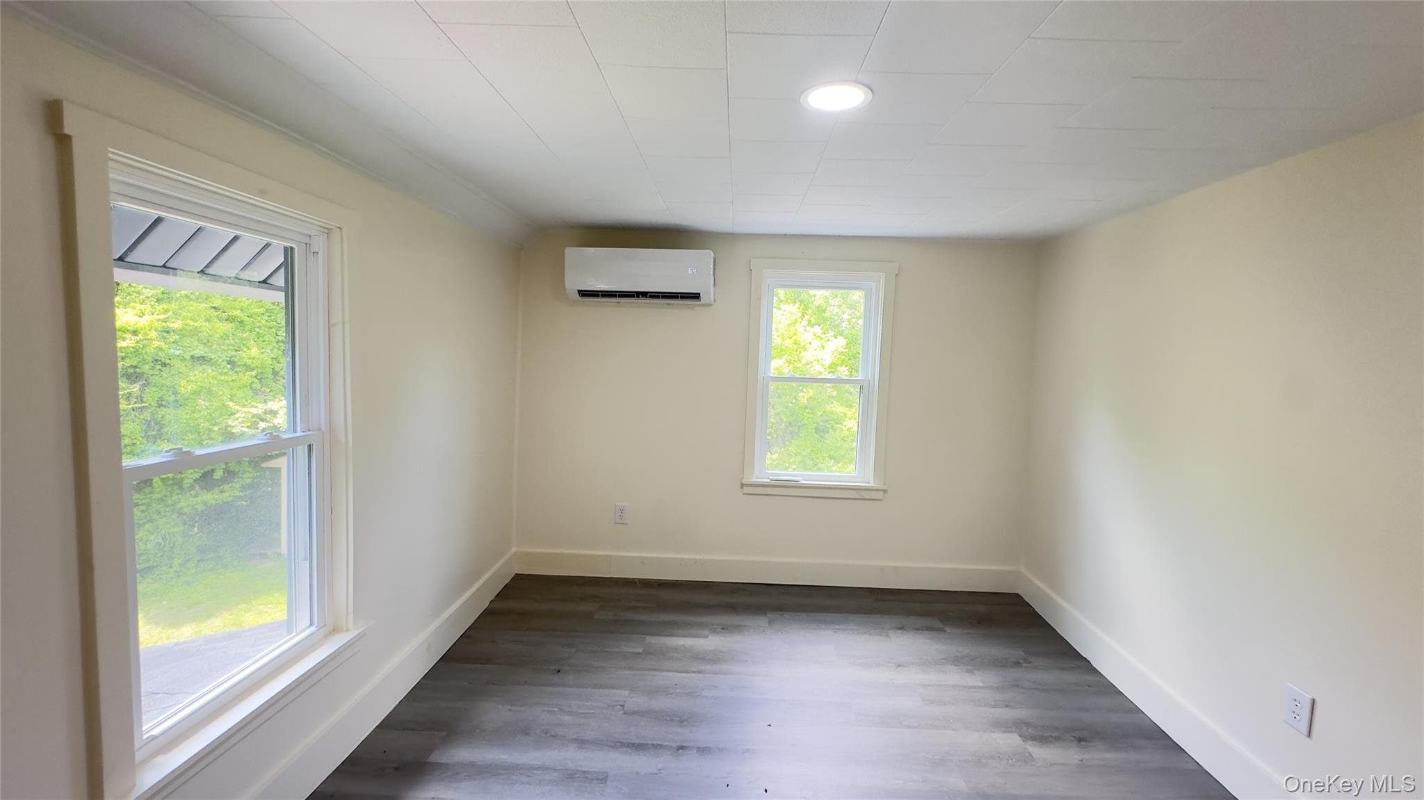 8 Marie Road, Unit 2 Highland, NY 12528 - Photo 6 of 15 an empty room with wooden floor and windows