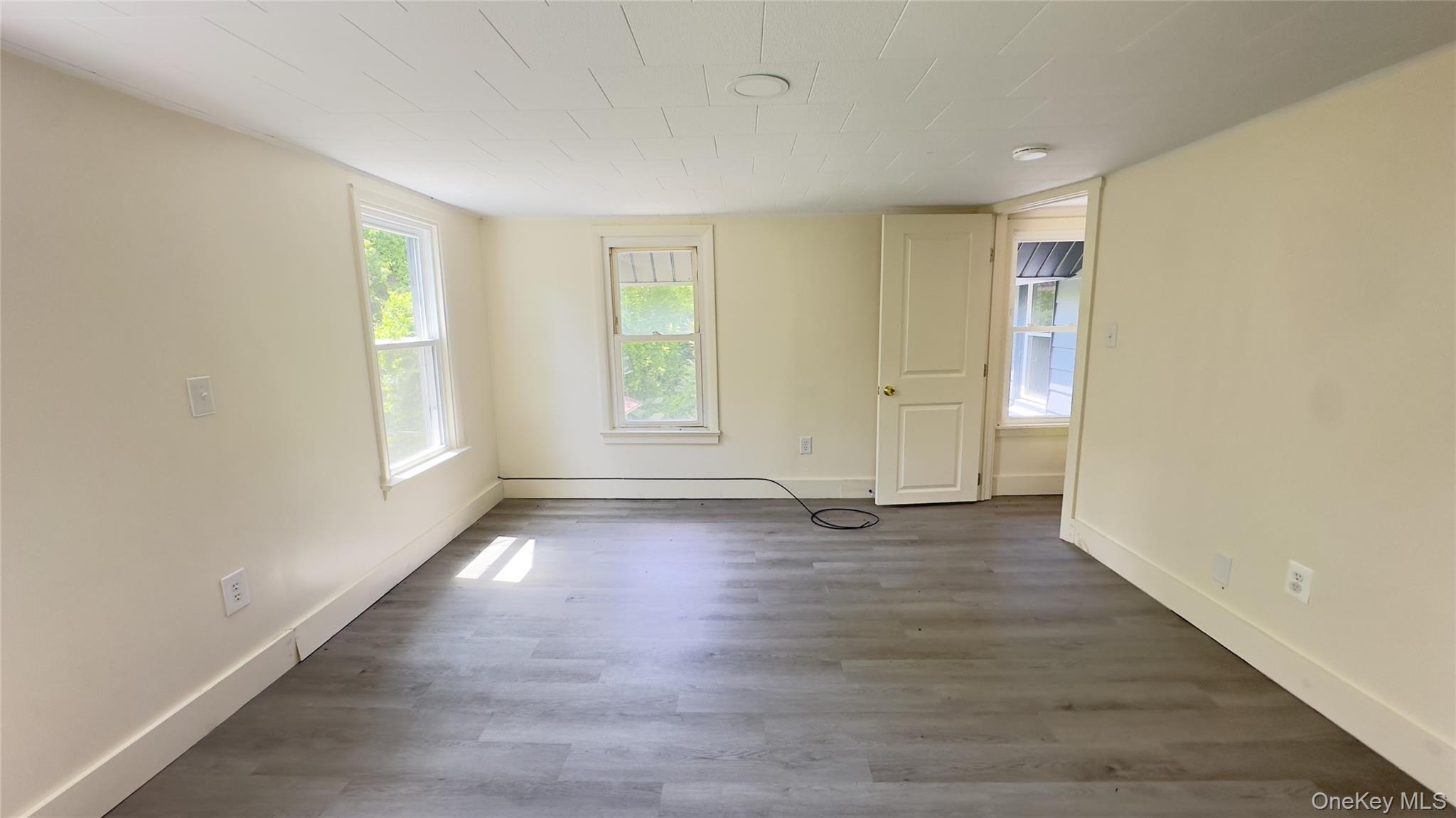 8 Marie Road, Unit 2 Highland, NY 12528 - Photo 7 of 15 an empty room with wooden floor and windows
