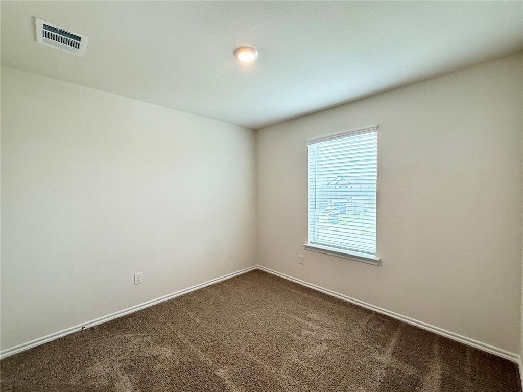 6114 Holly Spg Road Princeton, TX 75407 - Photo 6 of 7 an empty room with a window