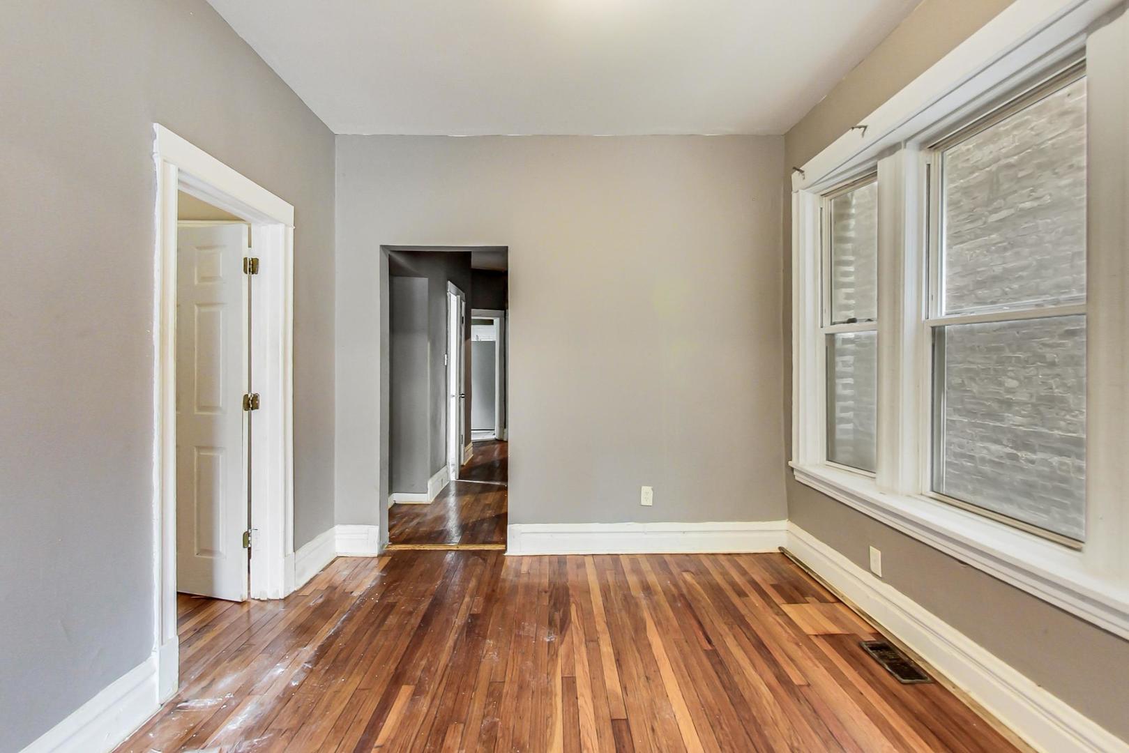 719 North Ridgeway Avenue Chicago, IL 60624 - Photo 11 of 58 a view of a room with wooden floor and window