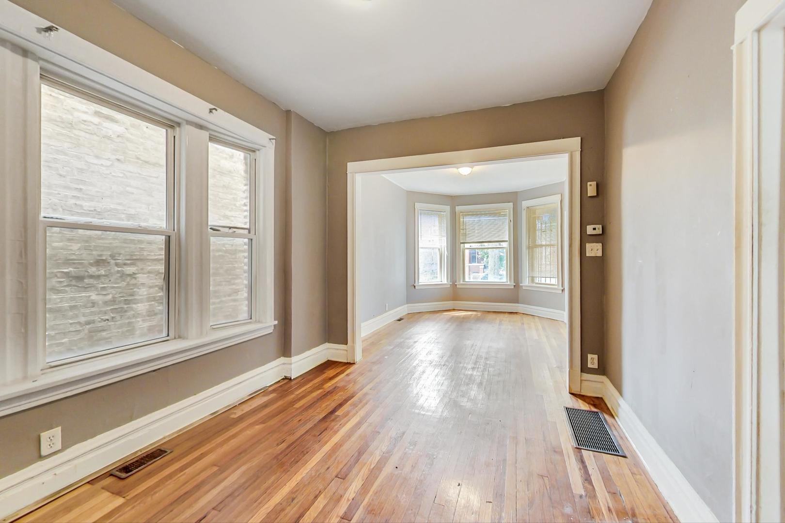 719 North Ridgeway Avenue Chicago, IL 60624 - Photo 12 of 58 a view of a room with wooden floor and doors