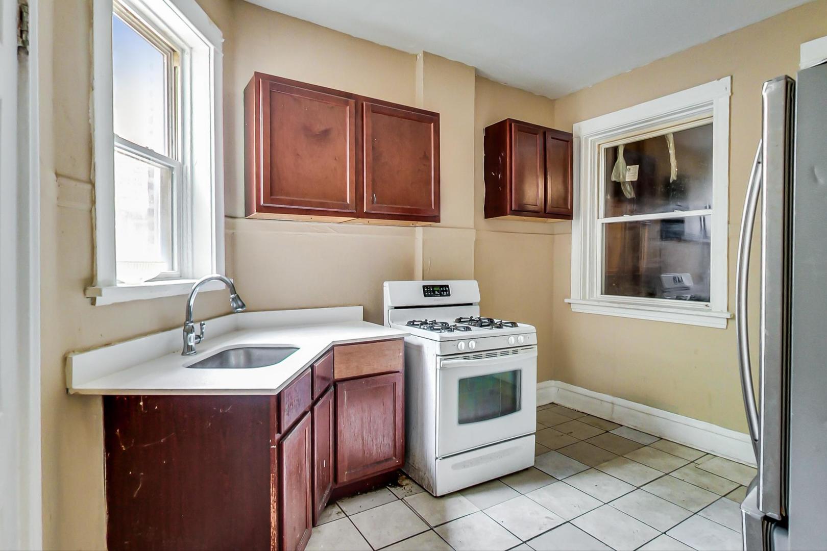 719 North Ridgeway Avenue Chicago, IL 60624 - Photo 13 of 58 a kitchen with stainless steel appliances granite countertop a stove a sink and a microwave