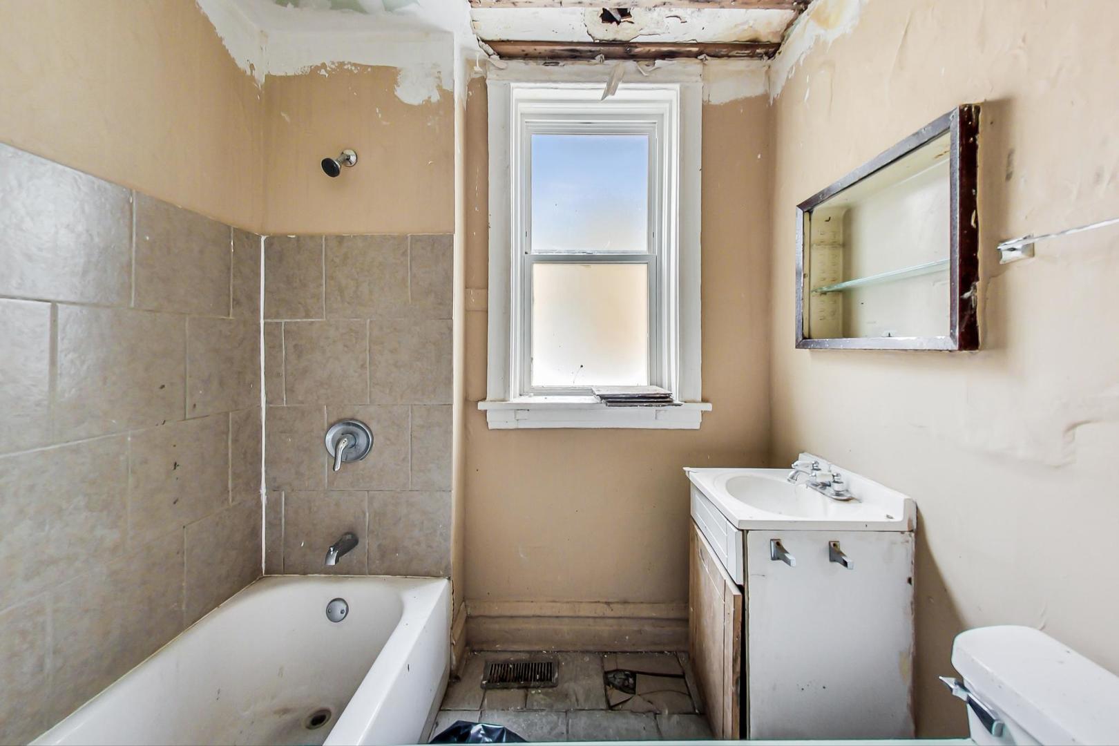 719 North Ridgeway Avenue Chicago, IL 60624 - Photo 16 of 58 a bathroom with a sink toilet and shower