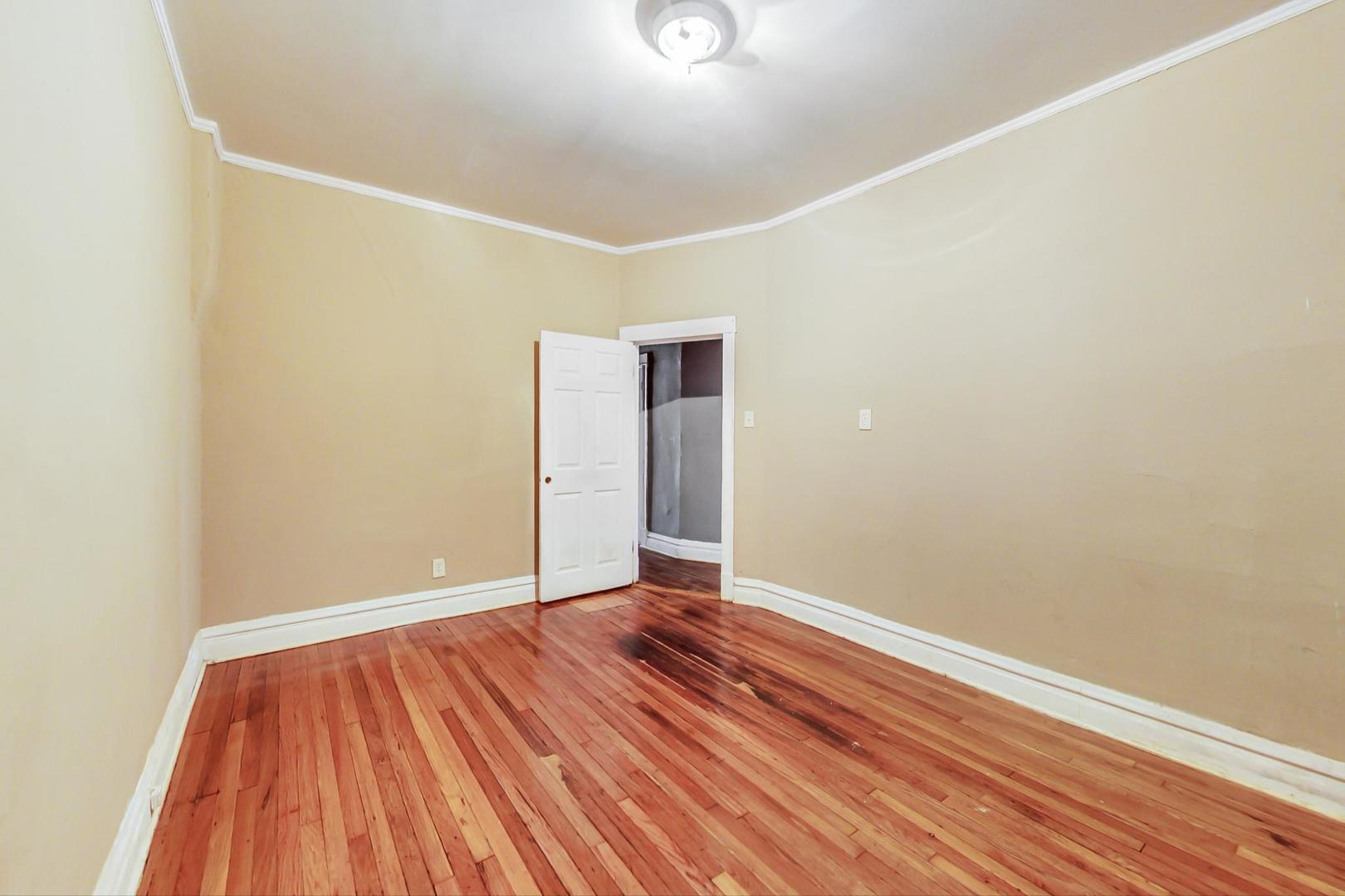 719 North Ridgeway Avenue Chicago, IL 60624 - Photo 18 of 58 a view of an empty room with wooden floor