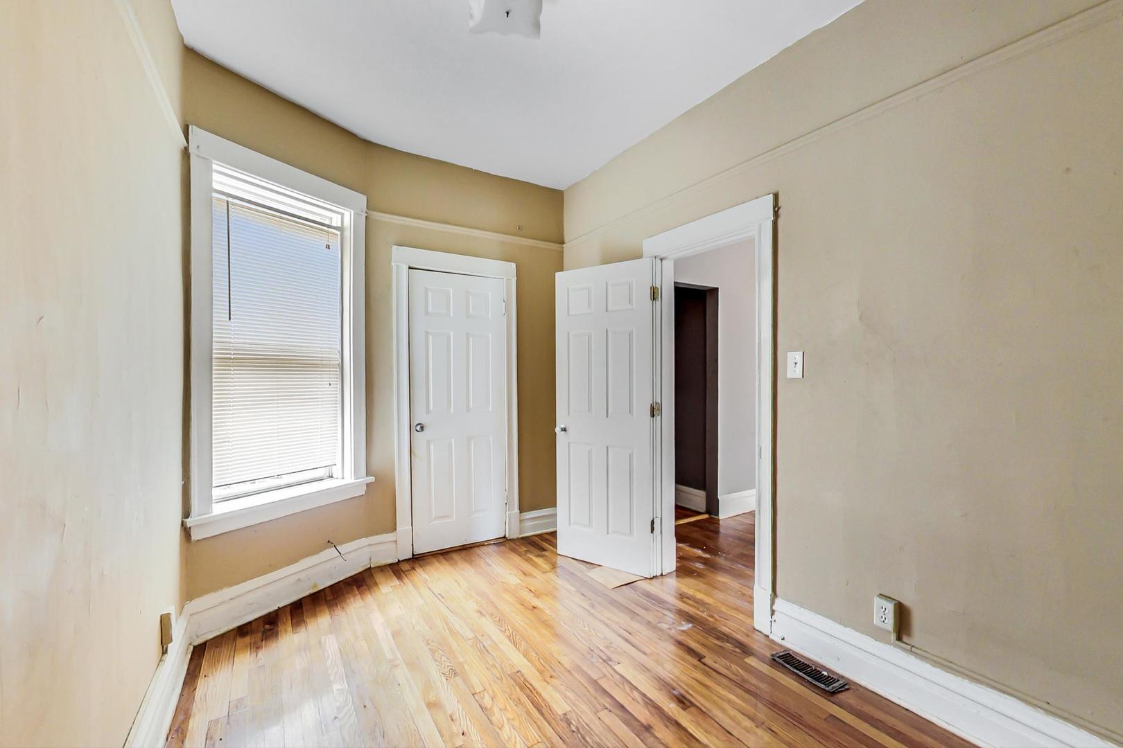 719 North Ridgeway Avenue Chicago, IL 60624 - Photo 23 of 58 an empty room with wooden floor and closet