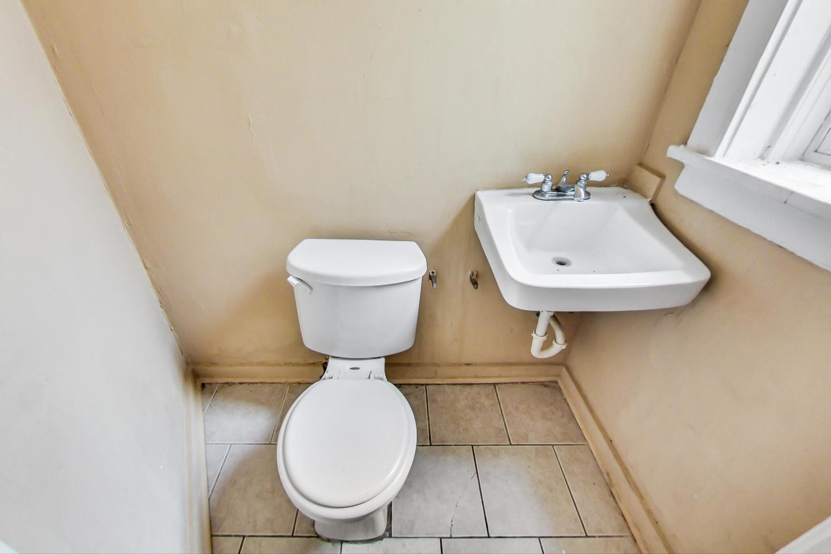 719 North Ridgeway Avenue Chicago, IL 60624 - Photo 24 of 58 a bathroom with a toilet sink and mirror