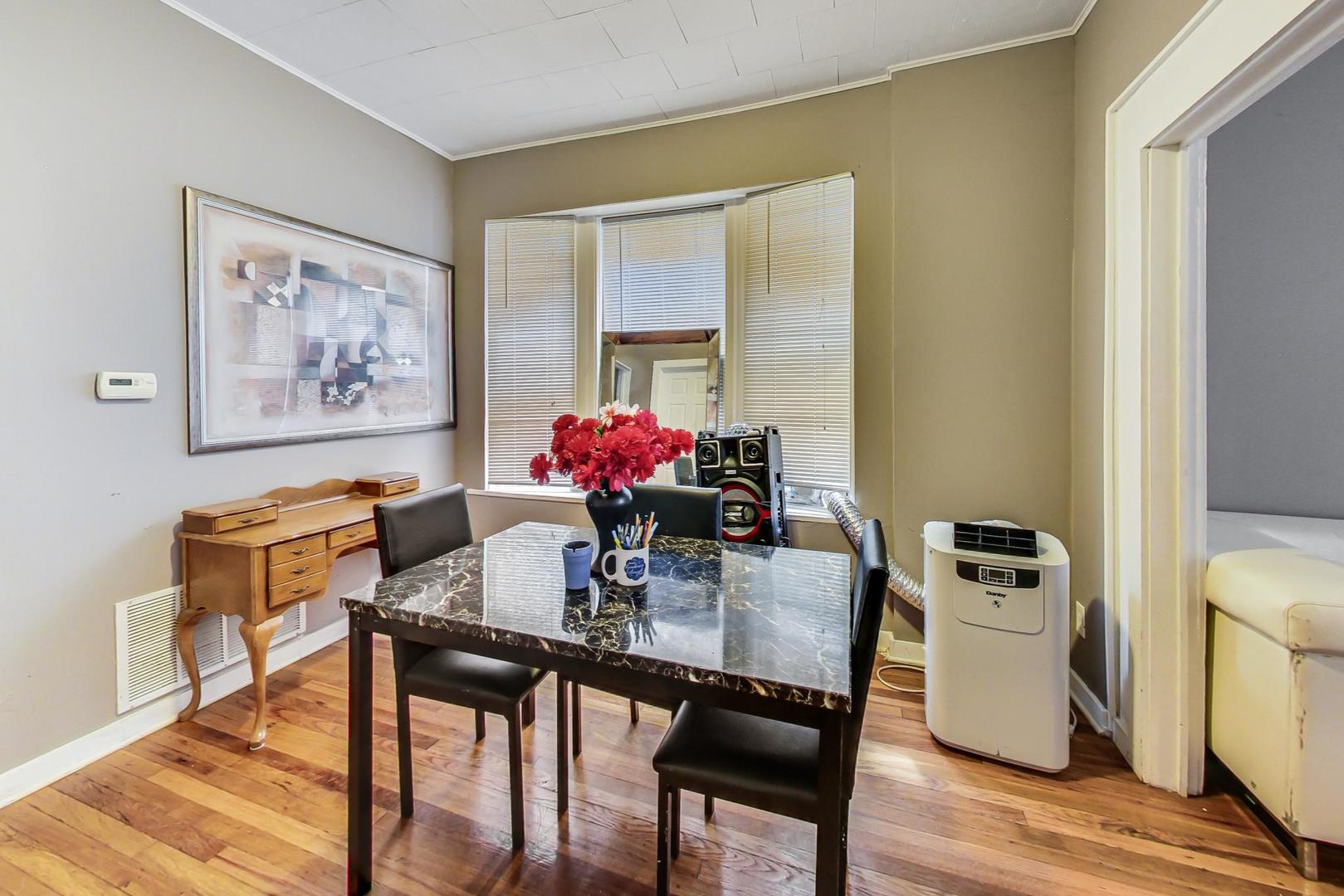719 North Ridgeway Avenue Chicago, IL 60624 - Photo 39 of 58 a dining room with furniture and wooden floor