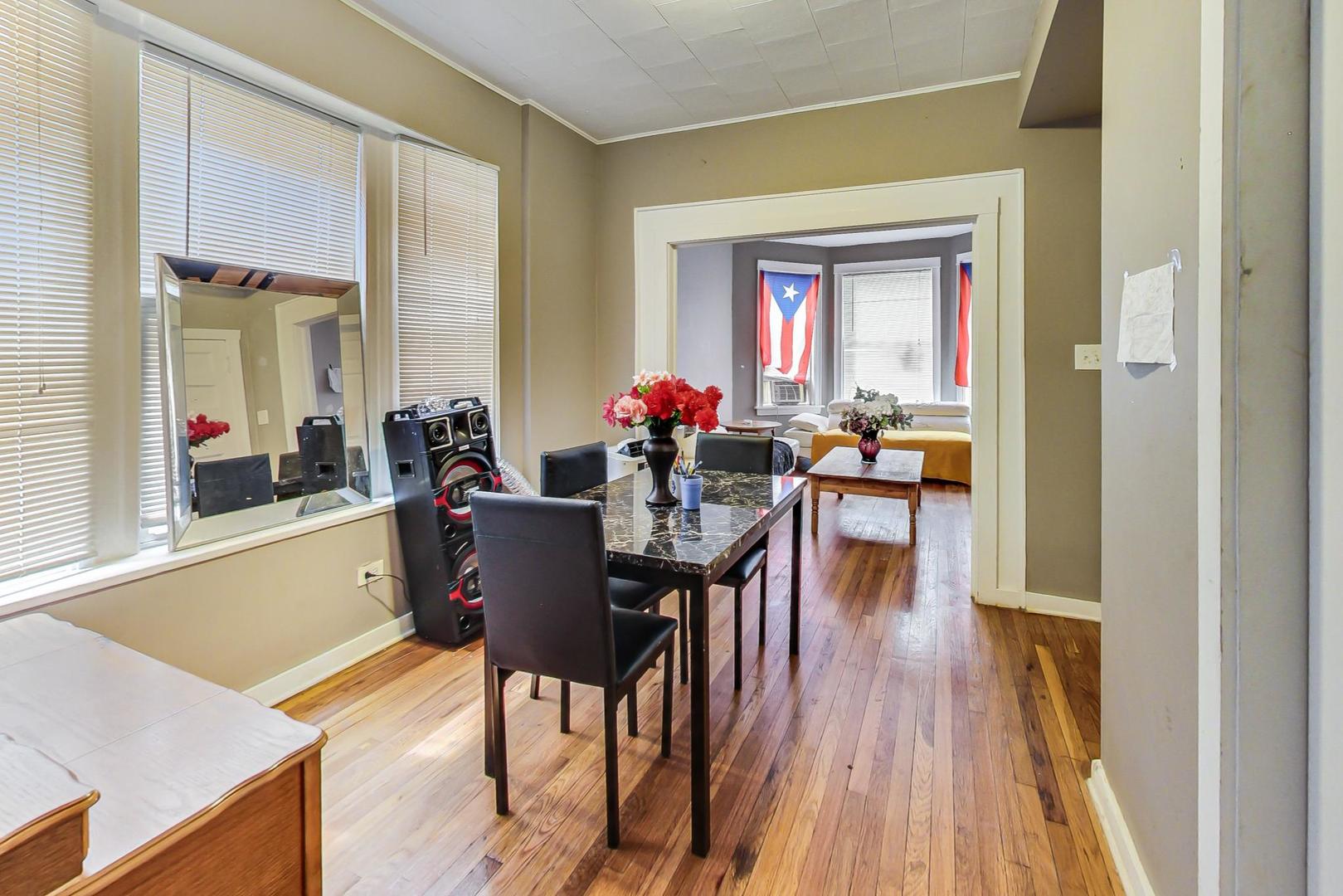 719 North Ridgeway Avenue Chicago, IL 60624 - Photo 40 of 58 a view of a dining room with furniture window and wooden floor