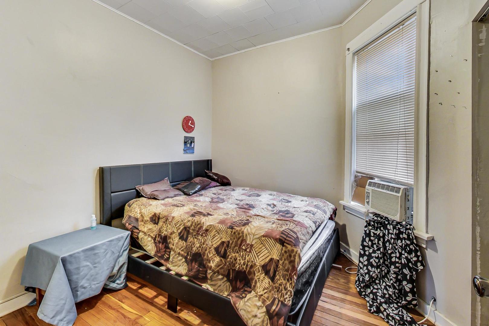 719 North Ridgeway Avenue Chicago, IL 60624 - Photo 48 of 58 a bedroom with a bed dresser and a window