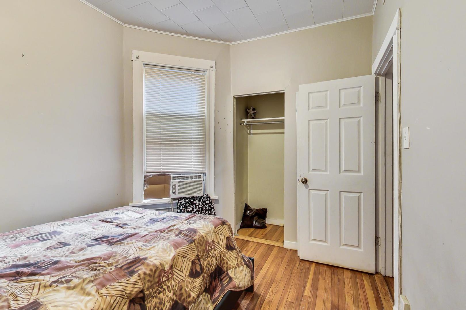 719 North Ridgeway Avenue Chicago, IL 60624 - Photo 49 of 58 a bedroom with a bed and a wooden floor