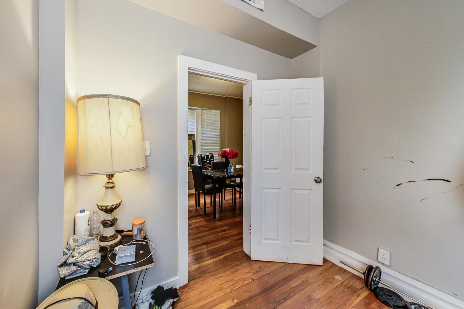 719 North Ridgeway Avenue Chicago, IL 60624 - Photo 51 of 58 a room with wooden floor and gym equipment