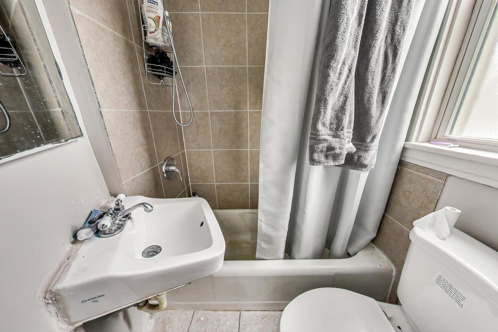 719 North Ridgeway Avenue Chicago, IL 60624 - Photo 54 of 58 a bathroom with a sink and toilet