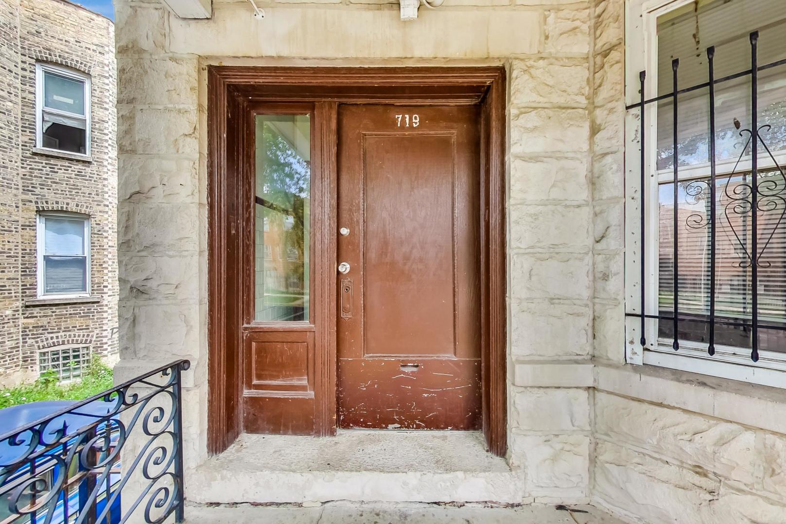 719 North Ridgeway Avenue Chicago, IL 60624 - Photo 7 of 58 a view of a wooden door with a brick house