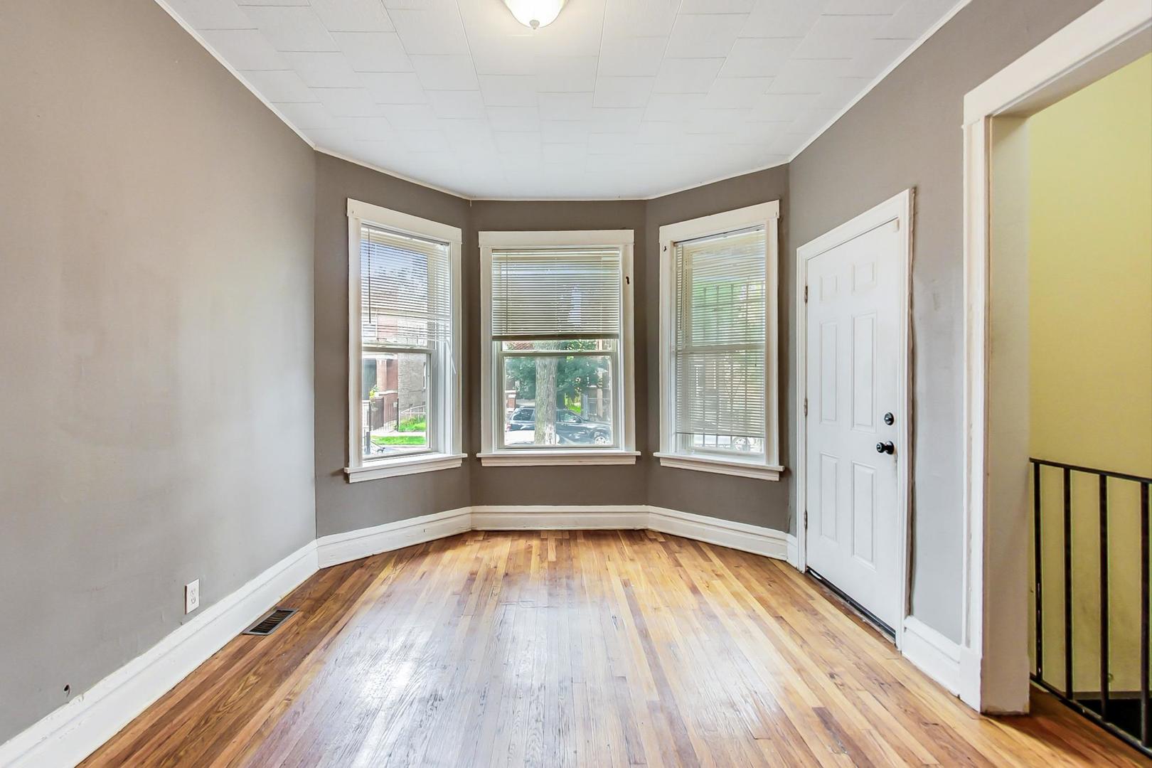 719 North Ridgeway Avenue Chicago, IL 60624 - Photo 9 of 58 a view of empty room with wooden floor and fan