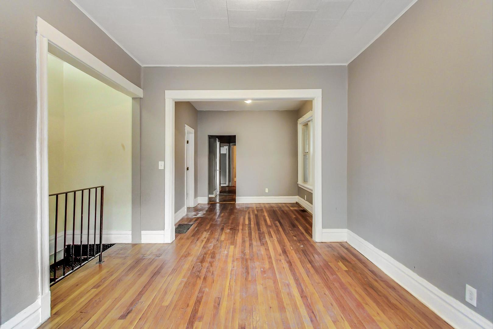 719 North Ridgeway Avenue Chicago, IL 60624 - Photo 10 of 58 a view of a room with wooden floor and a window