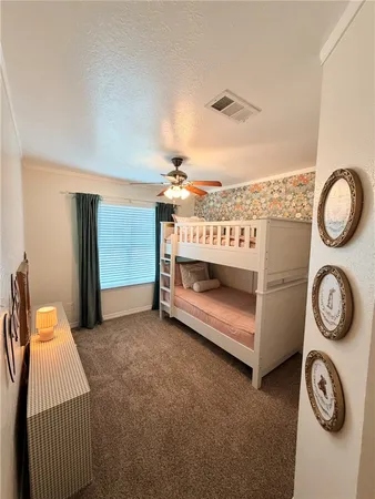 a spacious bedroom with a bed and a table in it