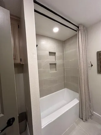 a bathroom with a bathtub and a shower