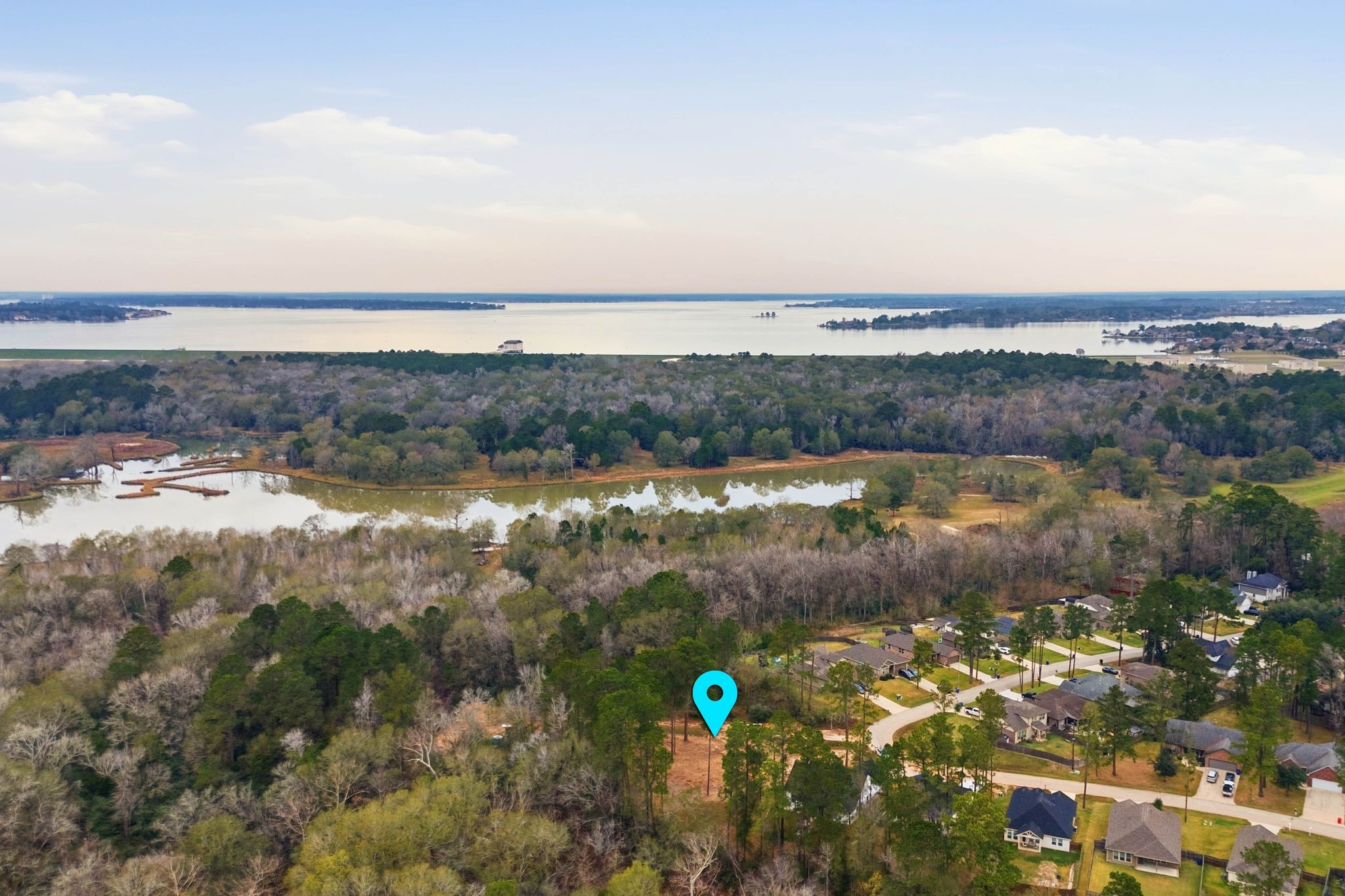 Tbd La Salle River Road Conroe, TX 77304 - Photo 7 of 8 a view of a lake with a city