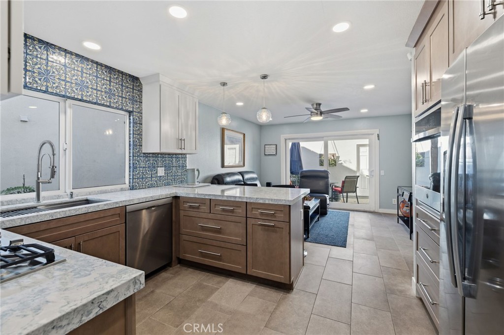 7 Spring Buck Irvine, CA 92614 - Photo 12 of 51 a kitchen with a sink stainless steel appliances and cabinets