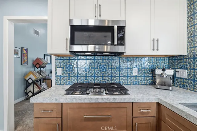 a kitchen with a stove a sink and a microwave