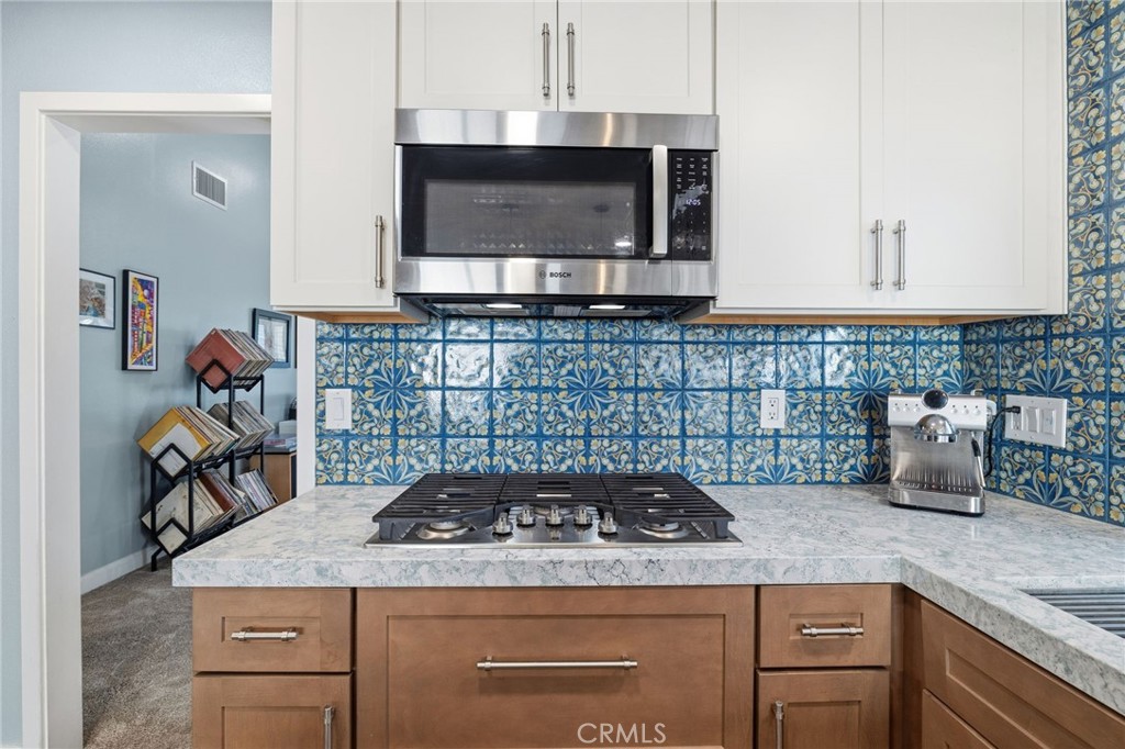 7 Spring Buck Irvine, CA 92614 - Photo 13 of 51 a kitchen with a stove a sink and a microwave