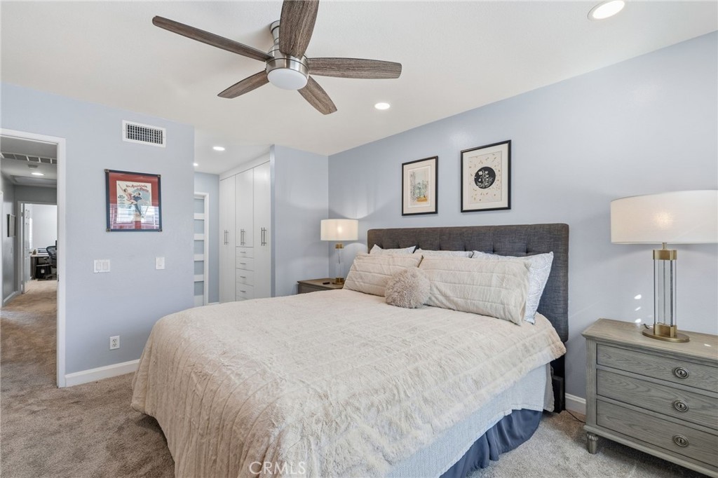 7 Spring Buck Irvine, CA 92614 - Photo 17 of 51 a bedroom with a bed and a lamp