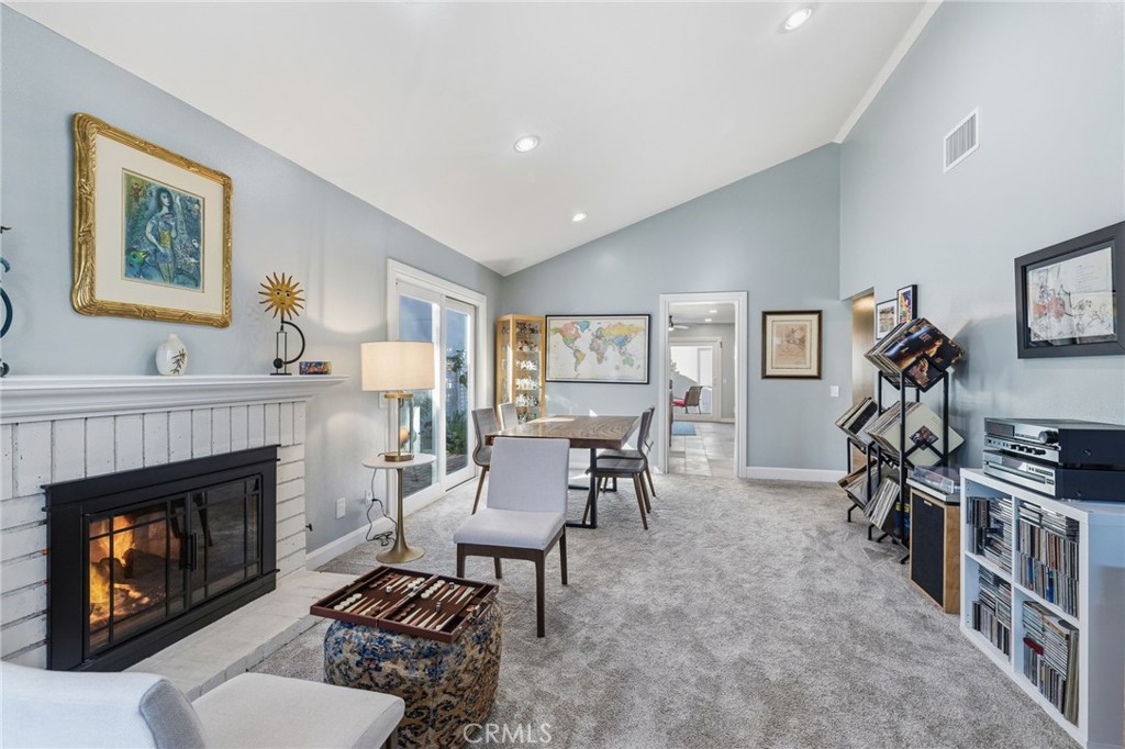 7 Spring Buck Irvine, CA 92614 - Photo 2 of 51 a living room with furniture a flat screen tv and a fireplace