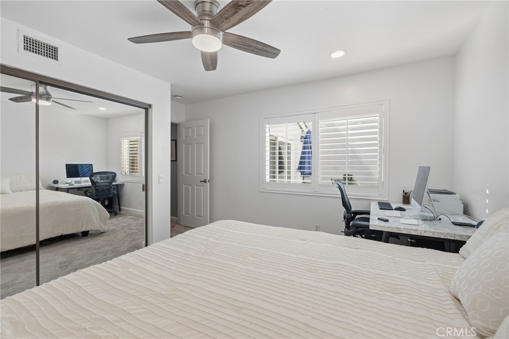 7 Spring Buck Irvine, CA 92614 - Photo 22 of 51 a bedroom with a bed and a chandelier