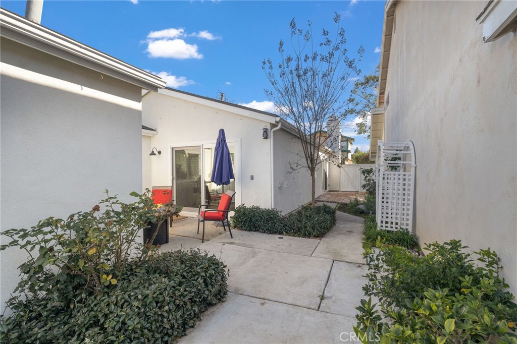7 Spring Buck Irvine, CA 92614 - Photo 26 of 51 a chair and table in front of a house
