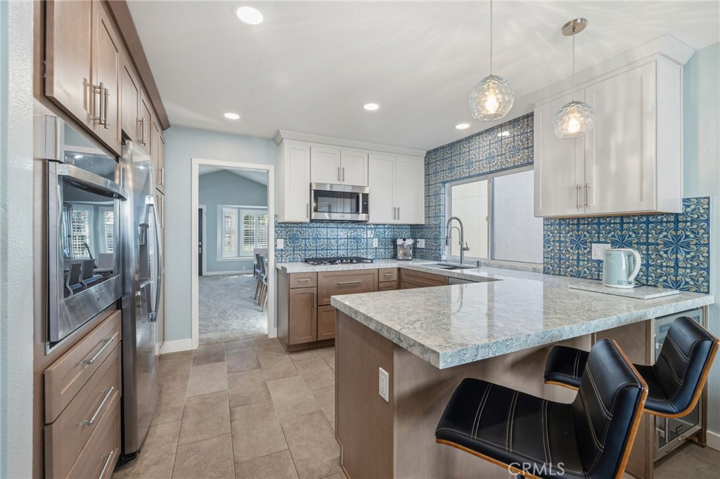 7 Spring Buck Irvine, CA 92614 - Photo 3 of 51 a kitchen with kitchen island a sink stove and refrigerator