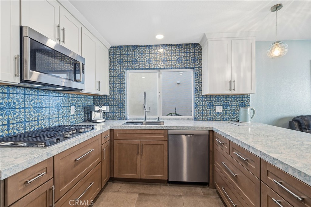 7 Spring Buck Irvine, CA 92614 - Photo 4 of 51 a kitchen with a sink stove and cabinets