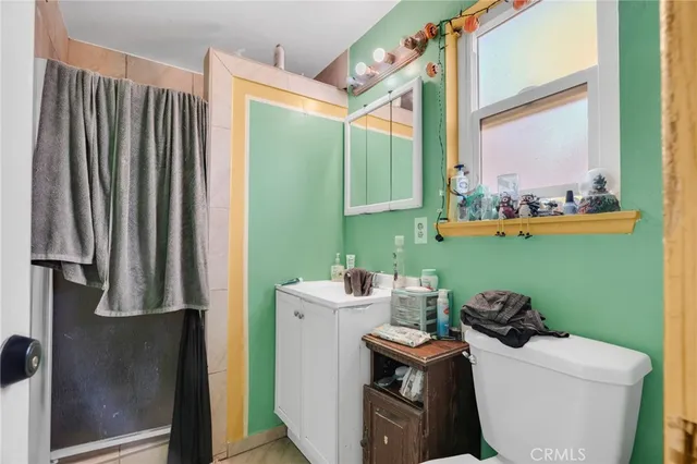 a bedroom with bed and a chandelier