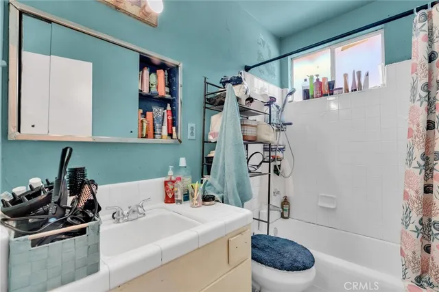 a bedroom with furniture and a flat screen tv